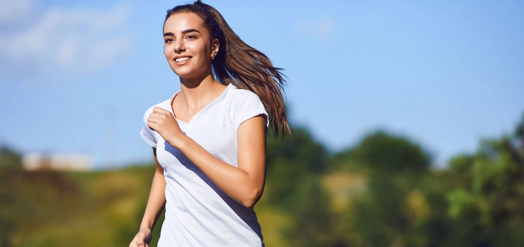 Vitamine C liposomale, femme souriante et pleine d'énergie